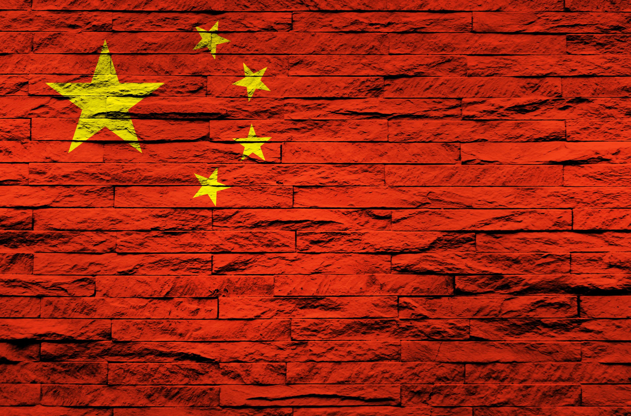 Chinese flag over a brick wall